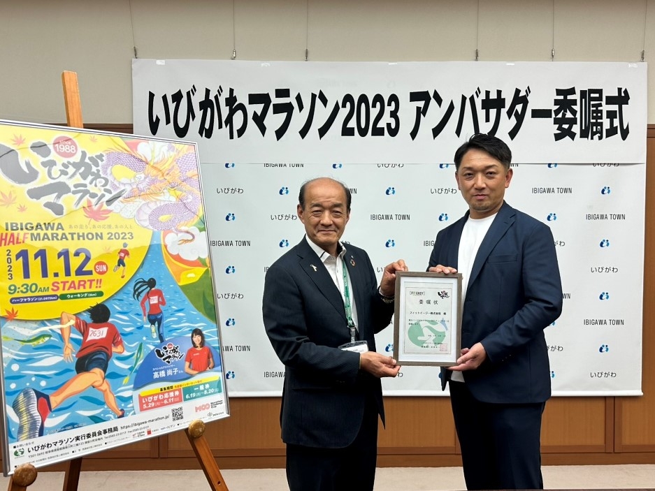 公式アンバサダー委嘱状を掲げる岡部栄一揖斐川町長（左）と中森勇樹副社長（右）