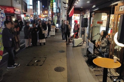栄通りを行き交う人々が足を止めて耳を傾ける7DAYS1DAYのサプライズフリーライブ。※観客の方の顔が写っている箇所には、プライバシー保護の観点から一部ぼかし加工を施しています。