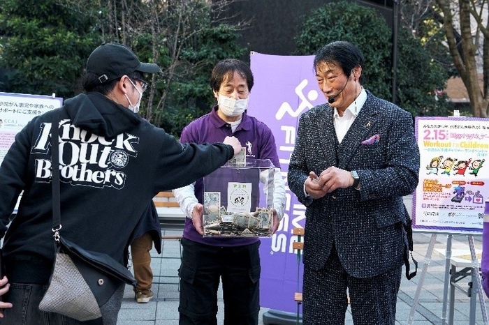 【募金活動での支援者と小橋建太氏(カメイドクロック)】