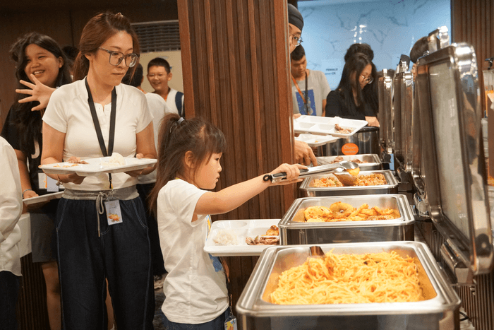 留学生がブッフェ形式の食事をとる様子