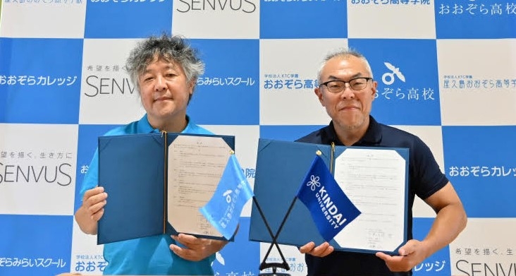 調印式の様子。屋久島おおぞら高等学校長 茂木 健一郎(左)と近畿大学通信教育部長 世耕 石弘(右)