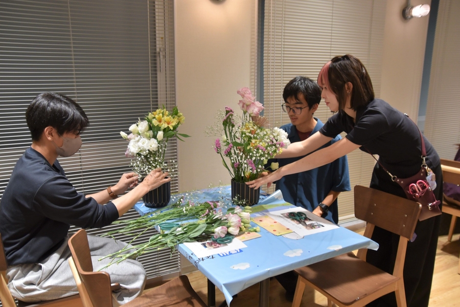 名古屋ウエディング＆フラワー・ビューティ学院の学生からアドバイスを受ける男子学生