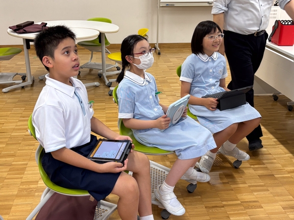 ライブ中継と英語でのコミュニケーションを楽しむ児童