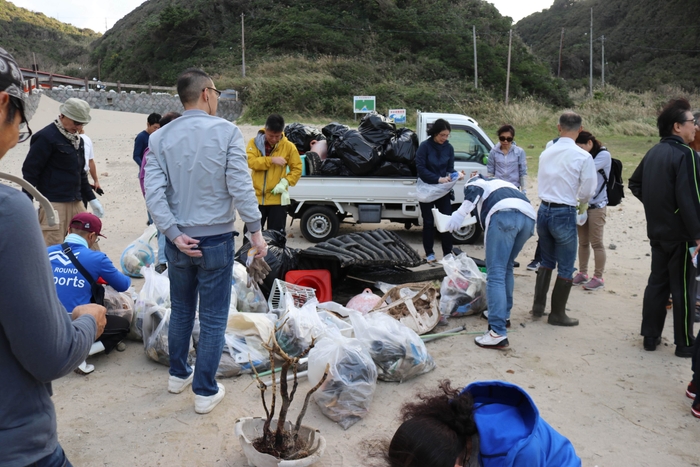 トラックの荷台から溢れる海岸のゴミ