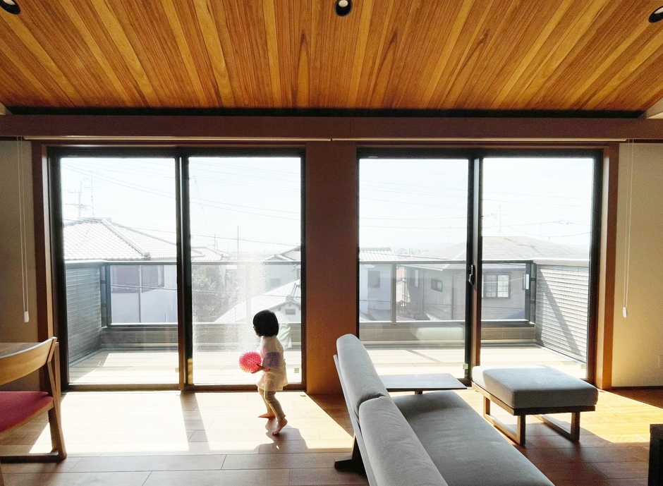 室内の床と同じ色味で外につながるフルフラットバルコニーで、リビングを広く見せる効果も