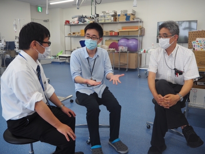 情報理工学科の赤木教授（右）、横田雅司助教（左）と打ち合わせる宮部助教（中央）