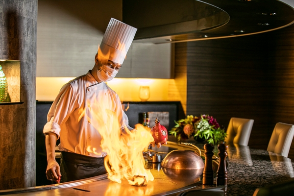 鉄板焼の醍醐味 パフォーマンス:絶妙な火入れで丁寧に焼き上げたハンバーグをフランベすることで、より豊かな香りに仕上げます