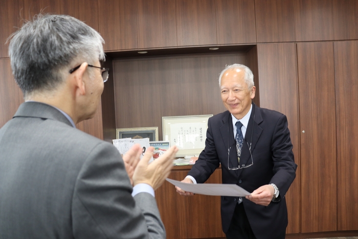 平野学長(左)から称号授与証を受け取る石垣元館長(右)