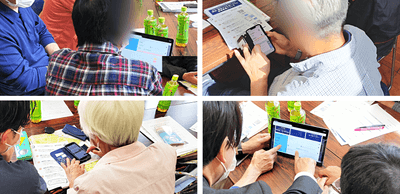 スマホやタブレットで入力を行う市民の方々