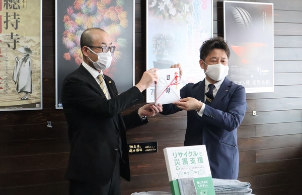 2021年3月25日に開催された贈呈式の様子(左:坂口副市長(当時)、右:加納店長)