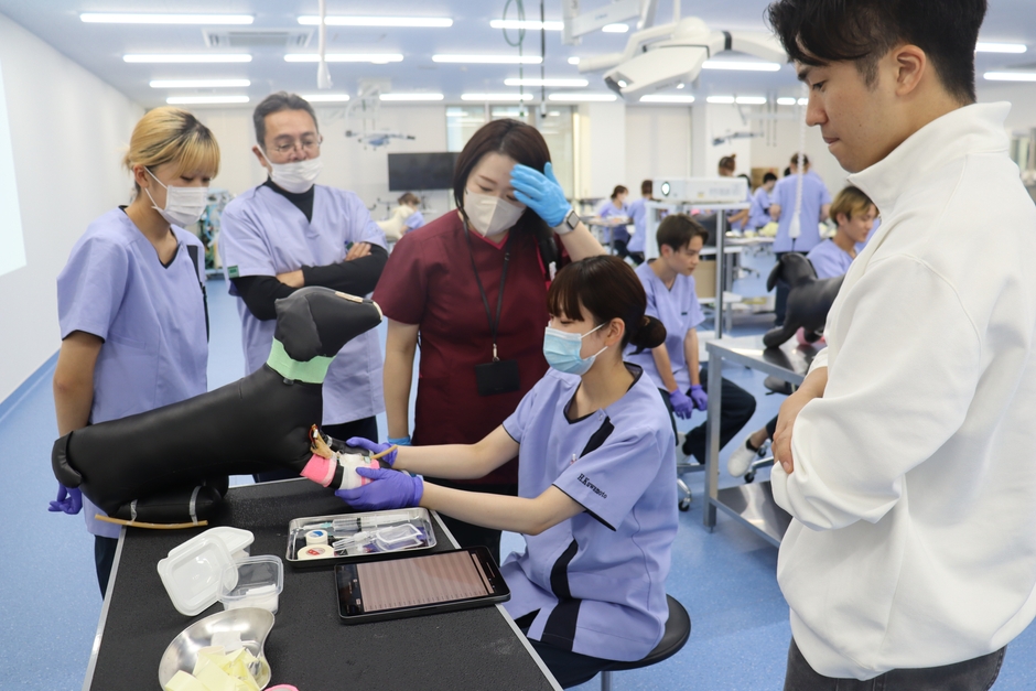 佐伯准教授(中央)は包帯の巻き方を熱心に指導