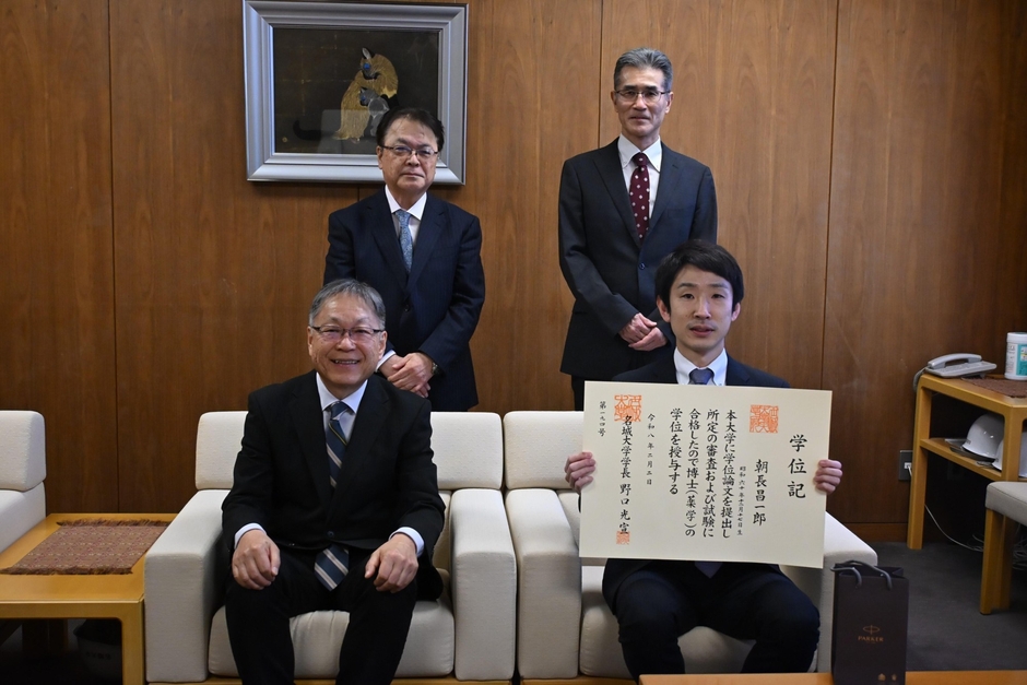 博士(薬学)の学位記を手にする朝長さん(前列右)と野口学長(同左)、(後列左から)亀井研究科長、論文主査の北垣教授