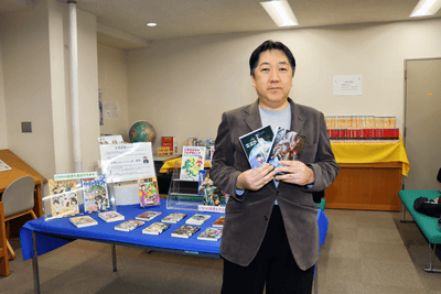 開発者・米村貴裕。商業出版した著作を手に
